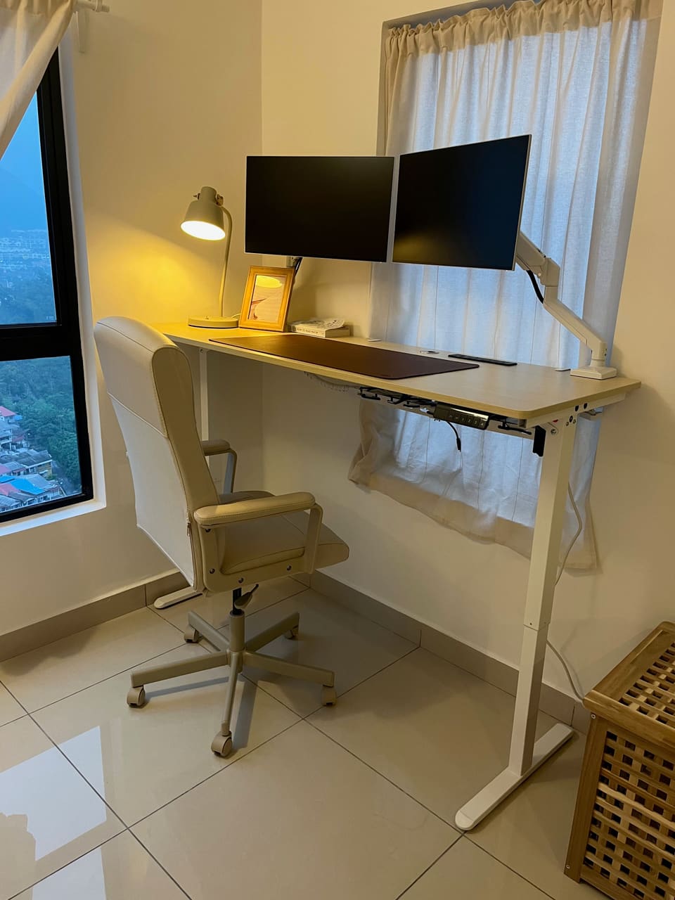 Desk set beside a window with a view over green hills