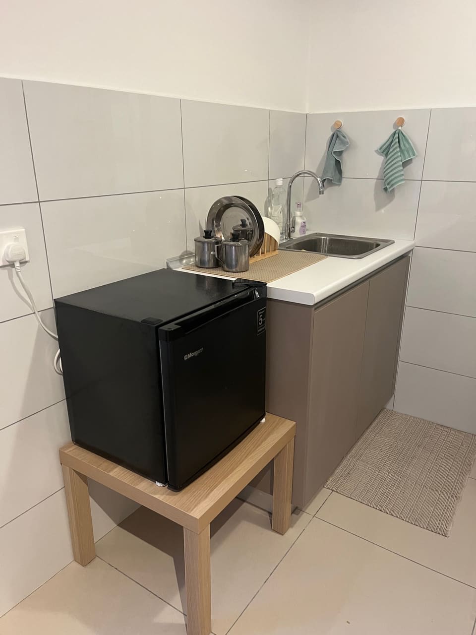 Kitchenette with sink, mini fridge and dish rack